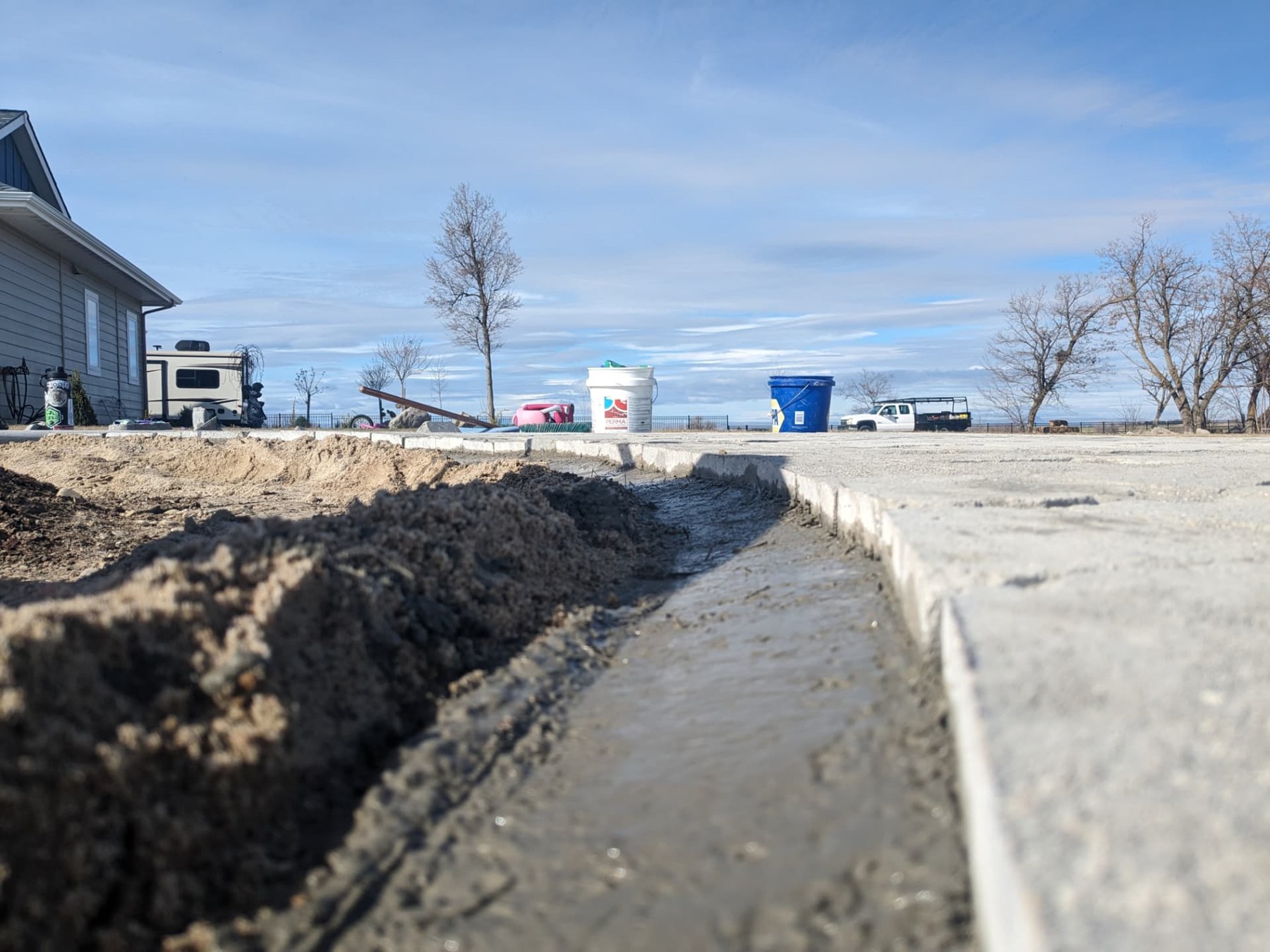 Close-up of the prepared edge beside a new paver patio