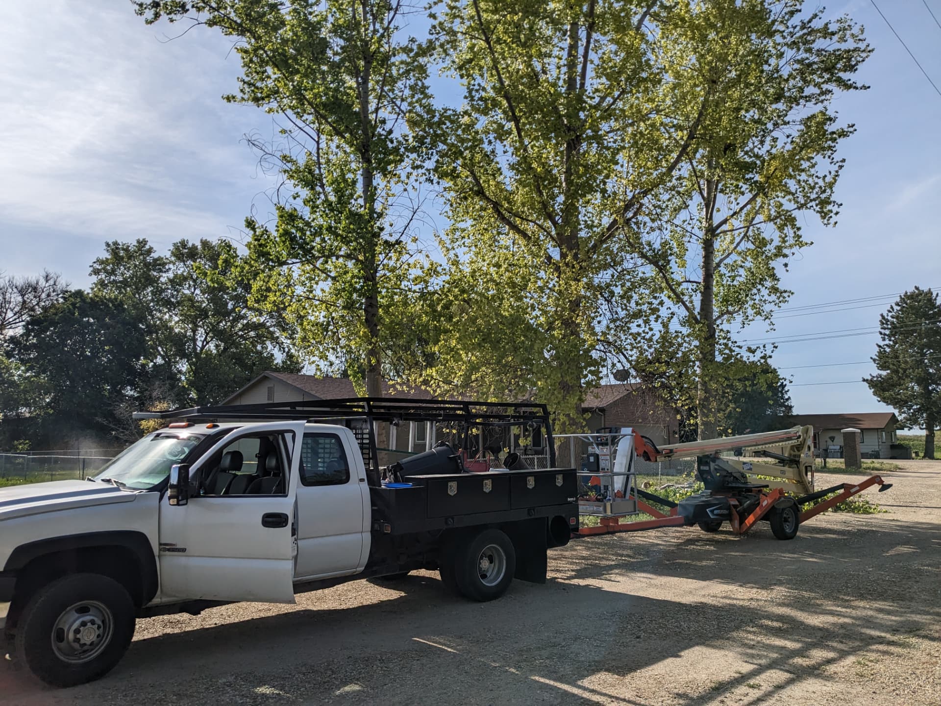 Home Maintenance Services truck and lift ready for a tree trimming job