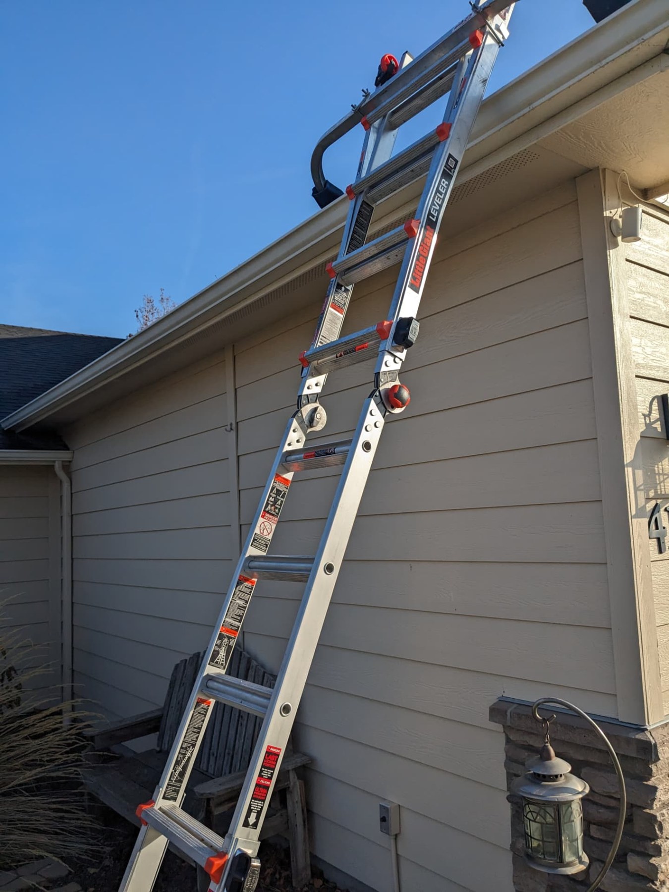 Extension ladder set up along a home's gutter for cleaning