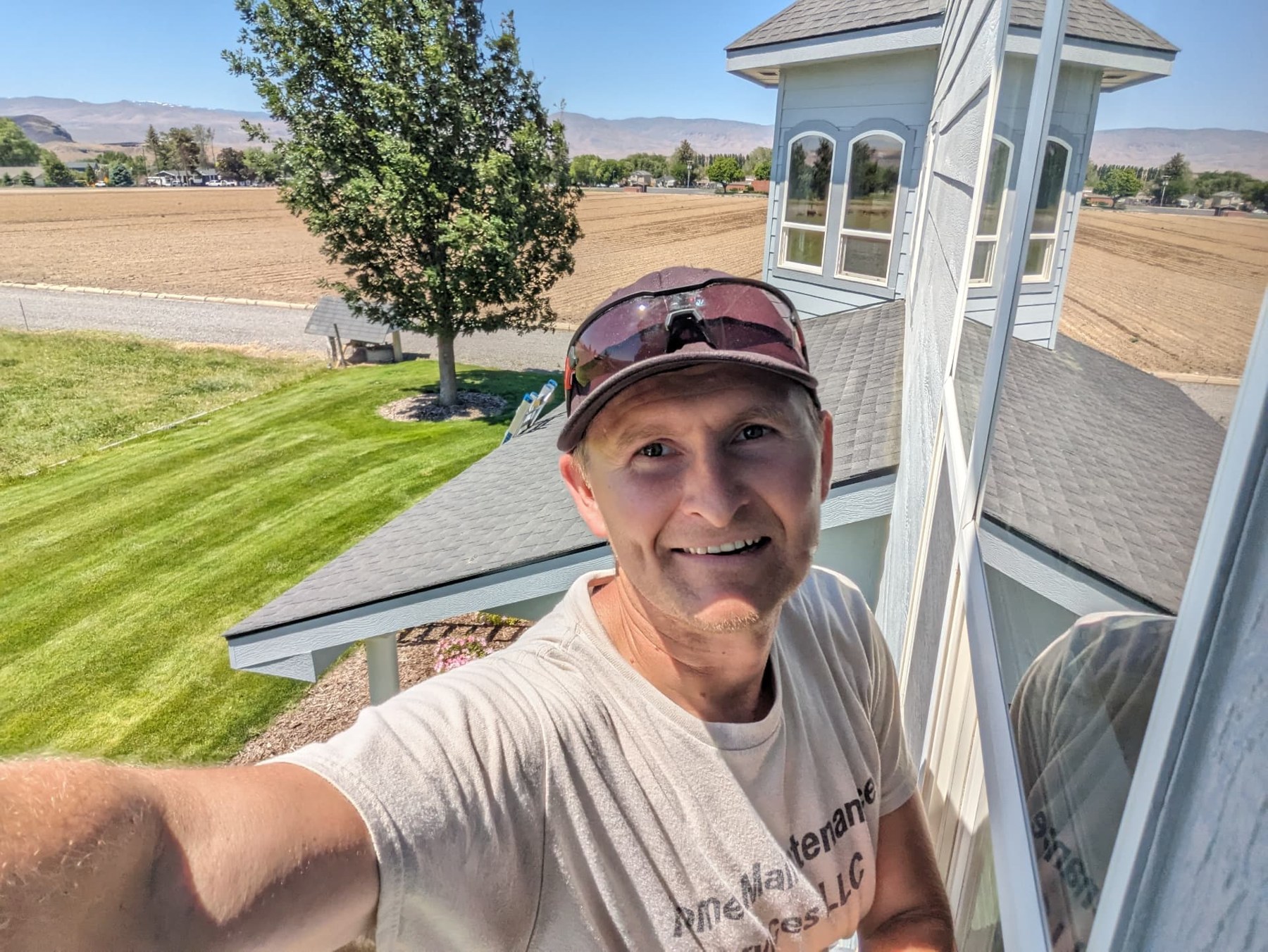 Crew member working beside the exterior of a home