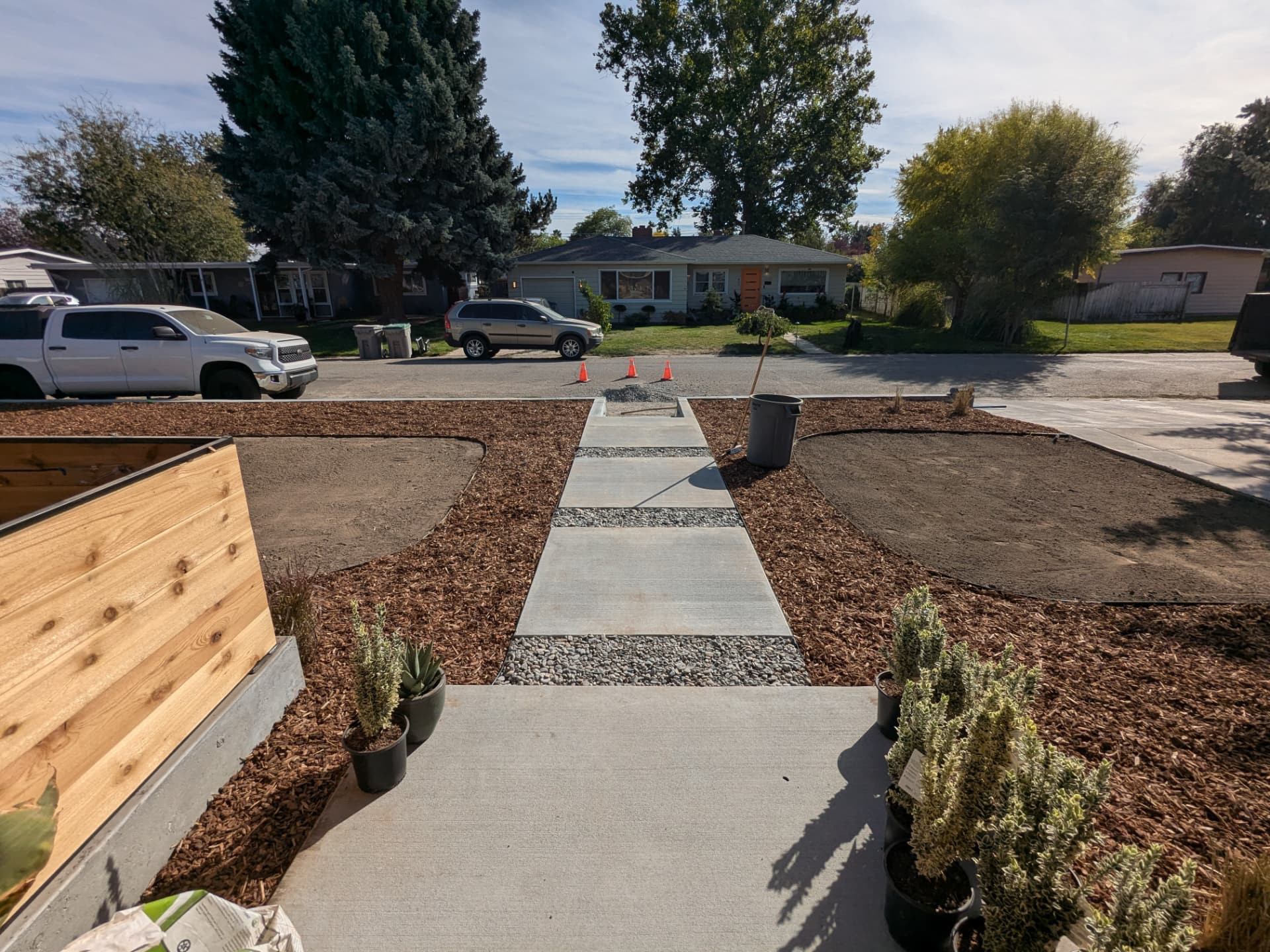 Paver walkway with rock joints flanked by newly mulched landscape beds