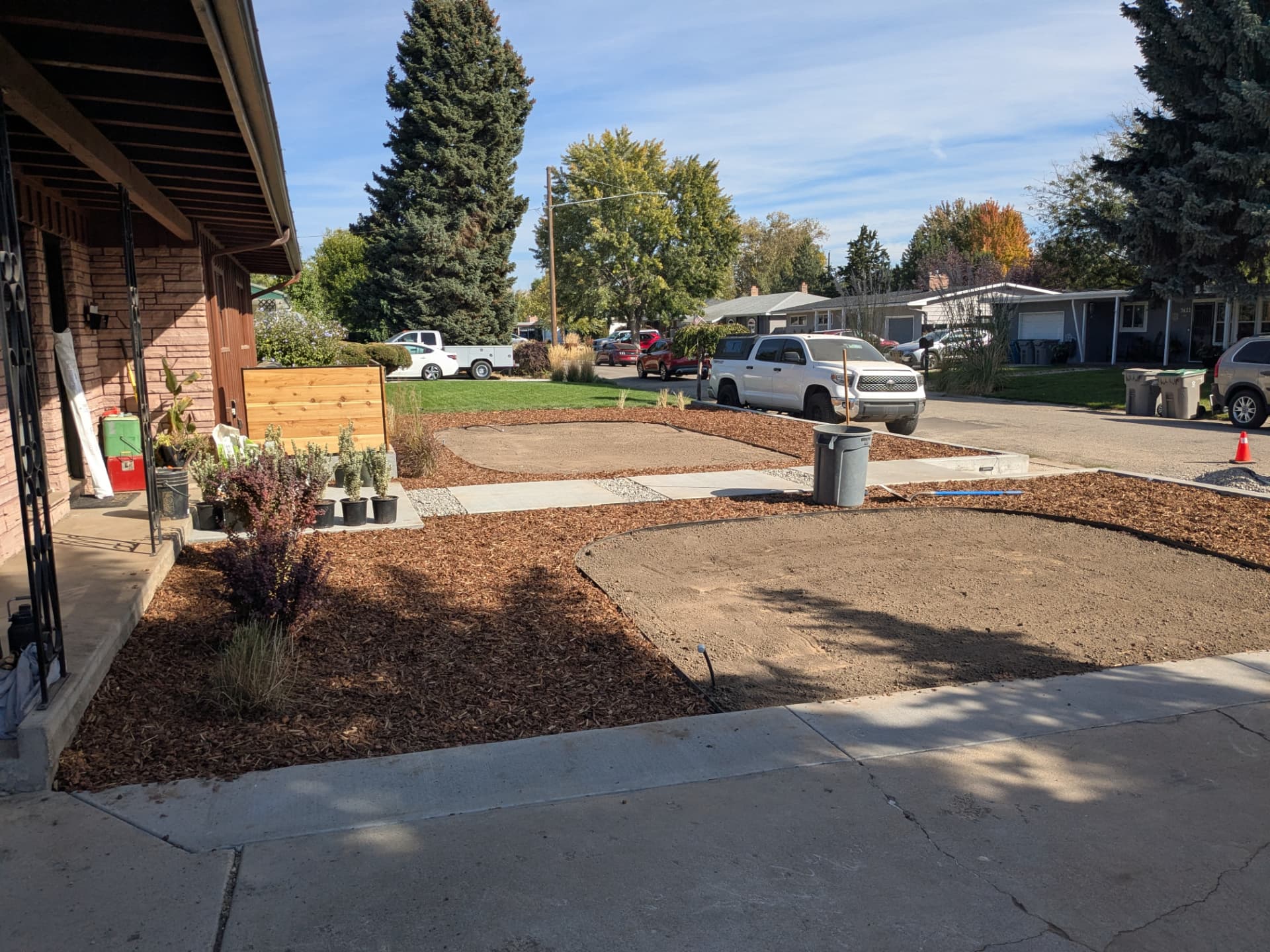 Freshly mulched landscape beds and prepared soil in a residential yard