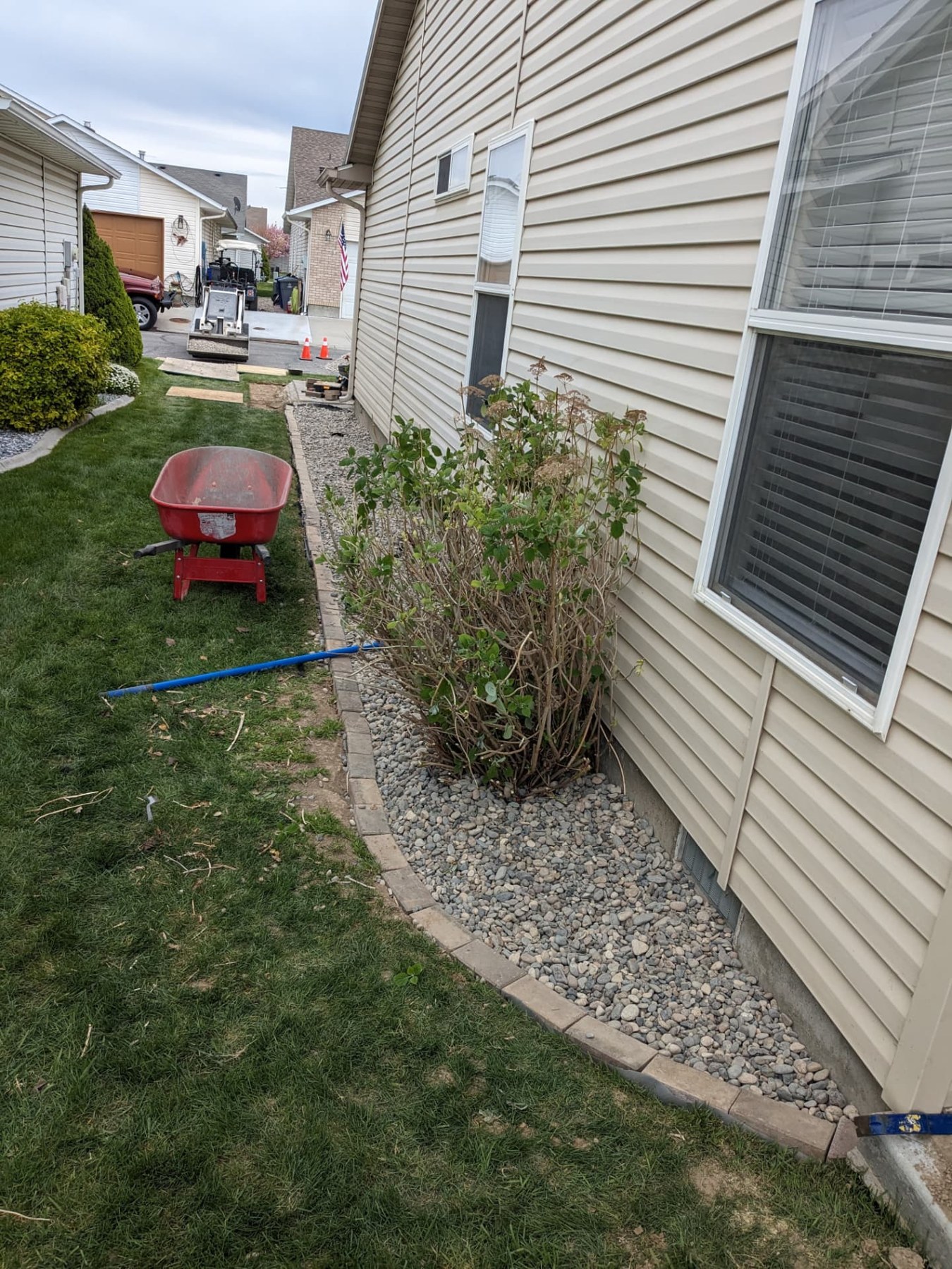 Fresh gravel landscaping bed along the side of a home